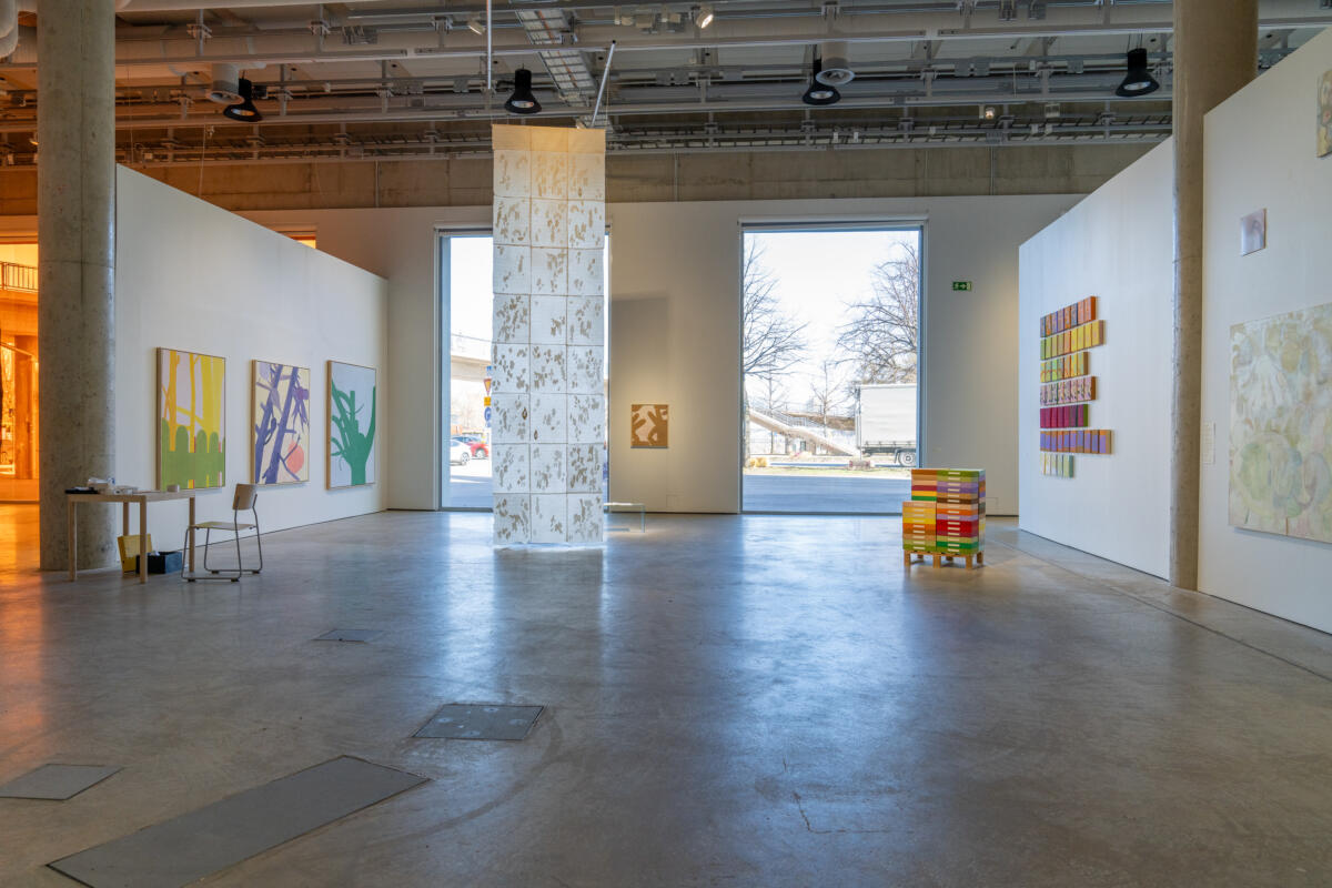 Artworks in a gallery with big windows. 